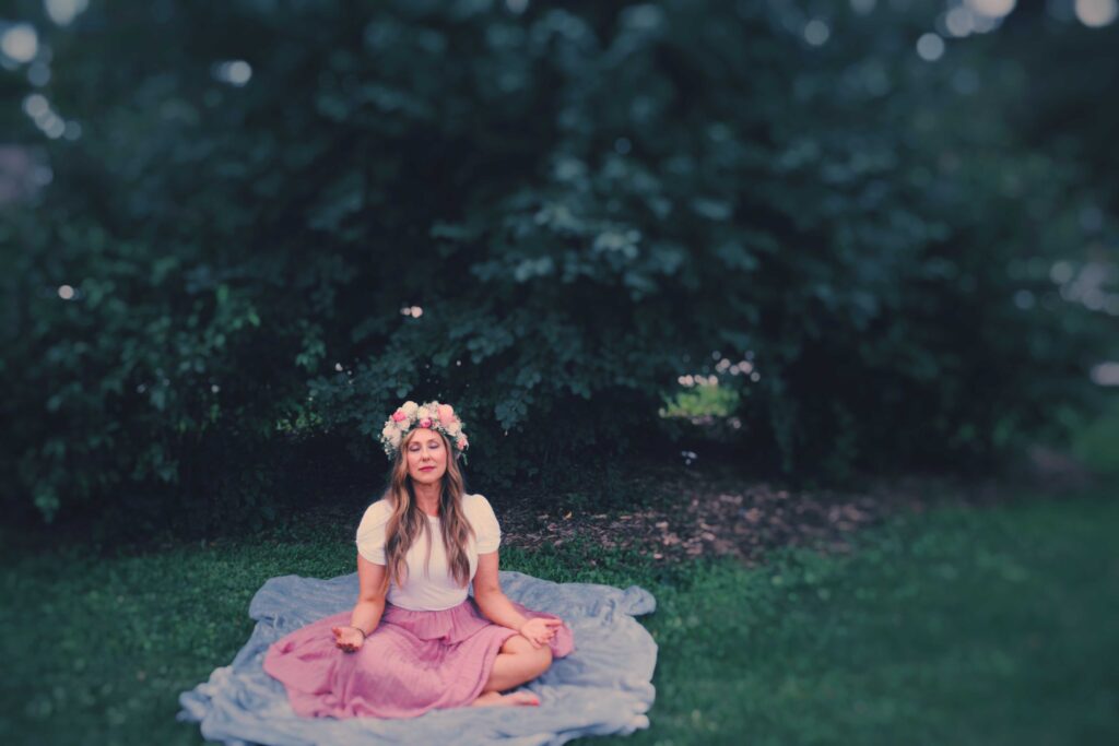 Sonia, the embodiment of Starling Salon, meditates in a quiet corner of the park under the protection of the watchful greenery.